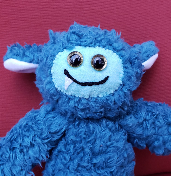 One-Fanged Teal Cozy Monster