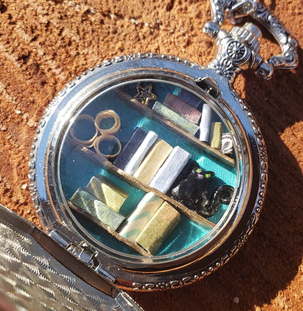 Silver Pocket Watch Library with Green-Eyed Black Cat