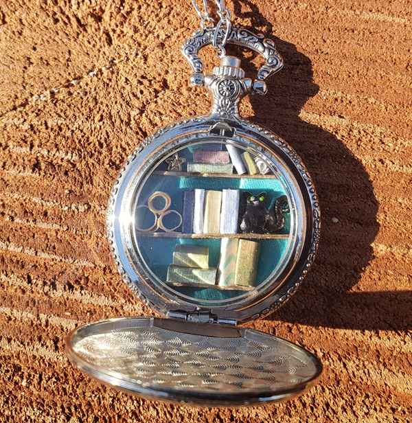 Silver Pocket Watch Library with Green-Eyed Black Cat